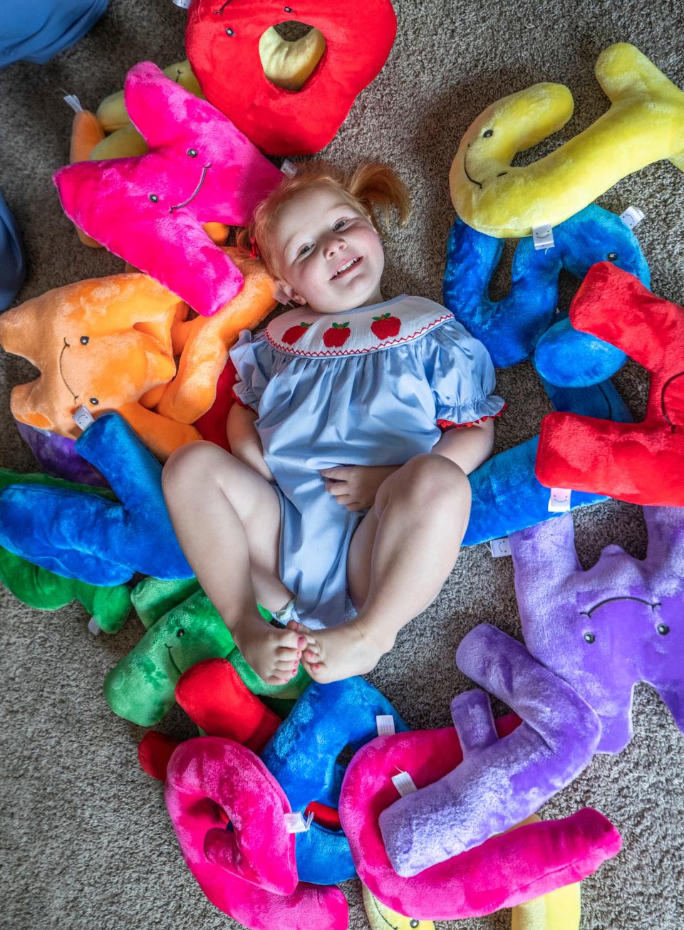 Isla McNabb, 2, was recently accepted as the youngest current member of Mensa, the society for people with high IQs. Here, she is surrounded by letters of the alphabet on Monday, June 13, 2022.