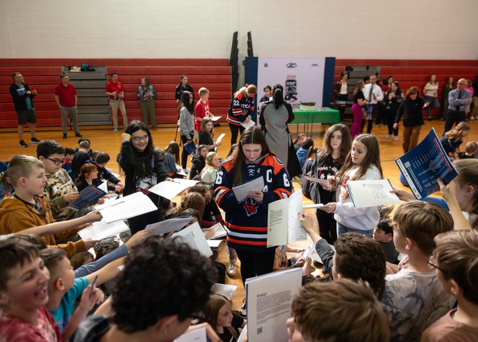 Students at Westmoreland Upper Elementary School wait patiently to get their IIHF 2024 WomenÕs World Championship Activity Books signed by Utica University women's hockey player Erica Sloan on Tuesday, February 27, 2024.