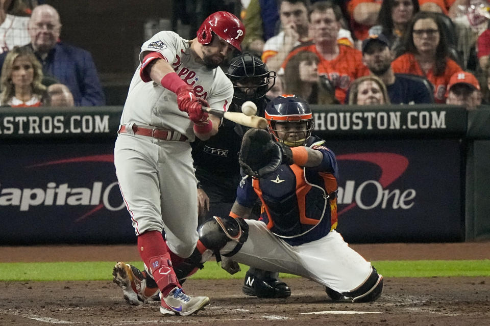 Philadelphia Phillies' Kyle Schwarber hits a single during the third inning in Game 2 of baseball's World Series between the Houston Astros and the Philadelphia Phillies on Saturday, Oct. 29, 2022, in Houston. (AP Photo/Sue Ogrocki)