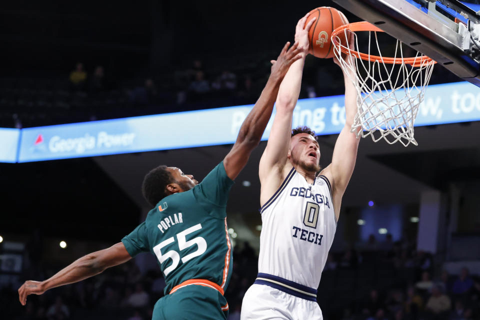 Georgia Tech guard Lance Terry, right, dunks next to Miami guard Wooga Poplar during the first half of an NCAA college basketball game Wednesday, Jan. 4, 2023, in Atlanta. (AP Photo/Alex Slitz)