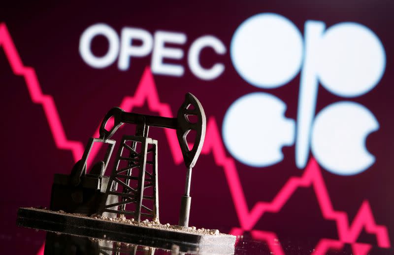 A 3D printed oil pump jack is seen in front of displayed stock graph and Opec logo in this illustration picture