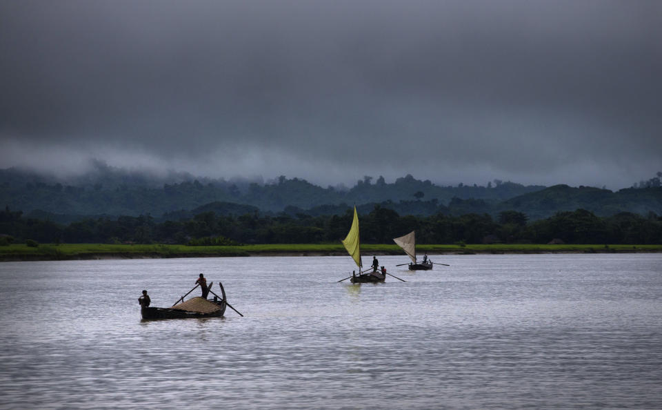 In this Sept. 16, 2013 photo, villagers transport merchandises in a river close to Buthidaung in Rakhine state, Myanmar. After closing its doors to the West for half a century, Myanmar has reopened, inviting all to come and discover its treasures, ancient palaces of kings long gone, legends and mysteries told in stone. With ill-equipped roads and railways, there is no better way to explore than by river. Public ferries crisscross through glistening green paddies; old teak fishing boats can be rented by the day. (AP Photo/Gemunu Amarasinghe)