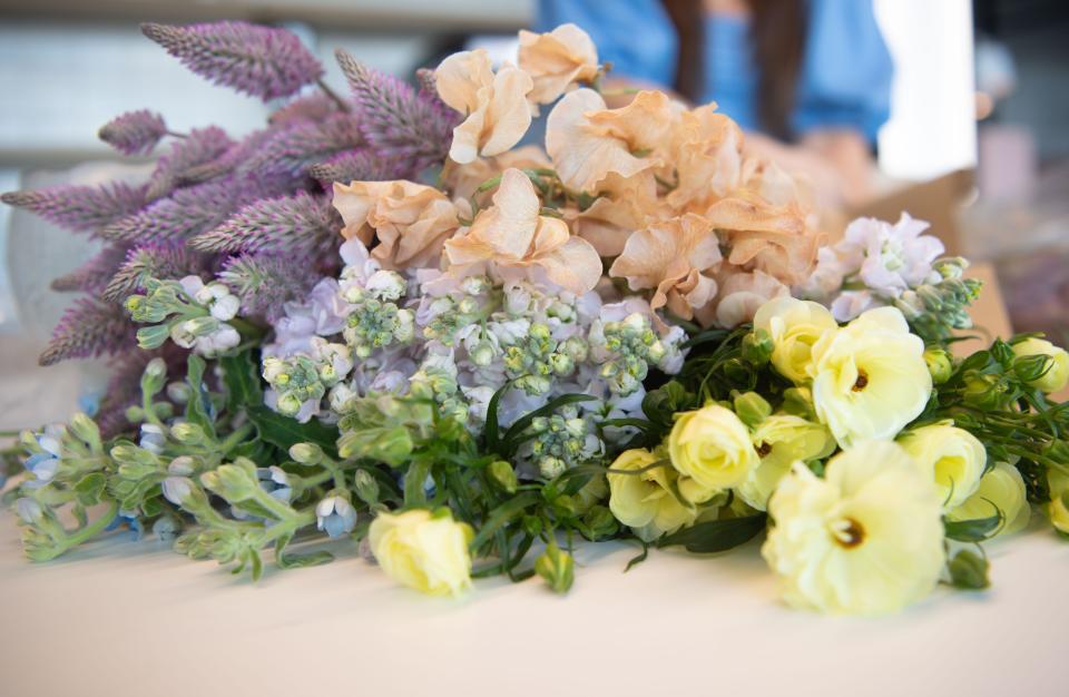 Alina Kamilchu sets a floral arrangement at the community lounge at Kenect in Nashville, Tenn., Thursday, March 24, 2022. Her family is still in Kiev and other Ukrainian cities. She will donate proceeds from flower arrangements to friends and family in Ukraine.