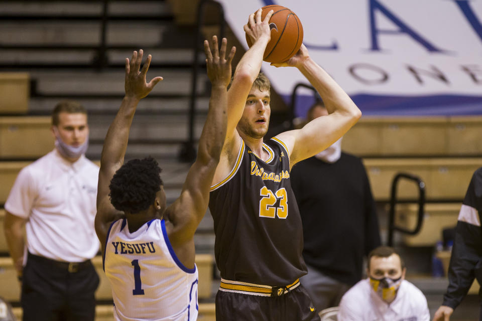 Valparaiso's Ben Krikke (23) looks to pass around Drake's Joseph Yesufu (1) during the second half of an NCAA college basketball game on Sunday, Feb. 7, 2021, in Valparaiso, Ind. (AP Photo/Robert Franklin)