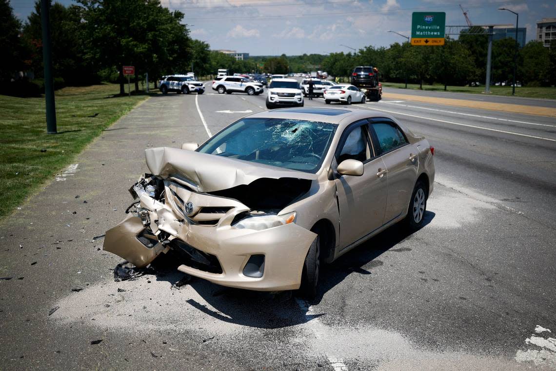 A stolen car sits near the intersection of Ballantyne Commons Parkway and Johnston Road following a pursuit that started on Intestate 77 in Charlotte, N.C., Wednesday, July 6, 2022.