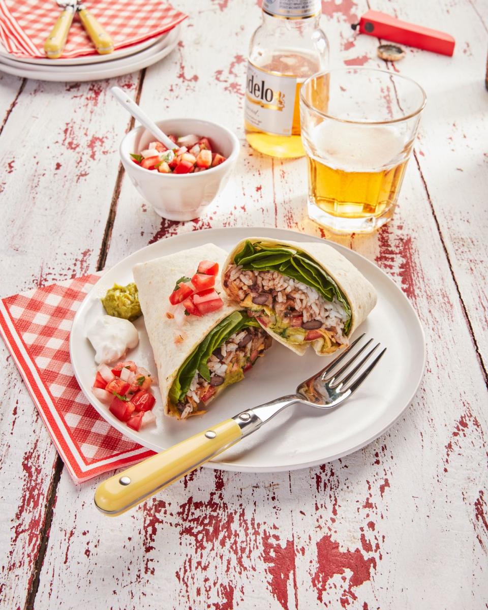 <p>Mix up a big batch of the rice and beans ahead of time, and you can simply roll up these healthy, tasty burritos in the morning before work. They're tasty hot or cold. </p><p><strong><a href="https://www.countryliving.com/food-drinks/a36343644/veggie-and-bean-burritos-recipe/" rel="nofollow noopener" target="_blank" data-ylk="slk:Get the recipe for Veggie-and-Bean Burritos;elm:context_link;itc:0;sec:content-canvas" class="link ">Get the recipe for Veggie-and-Bean Burritos</a>.</strong></p>