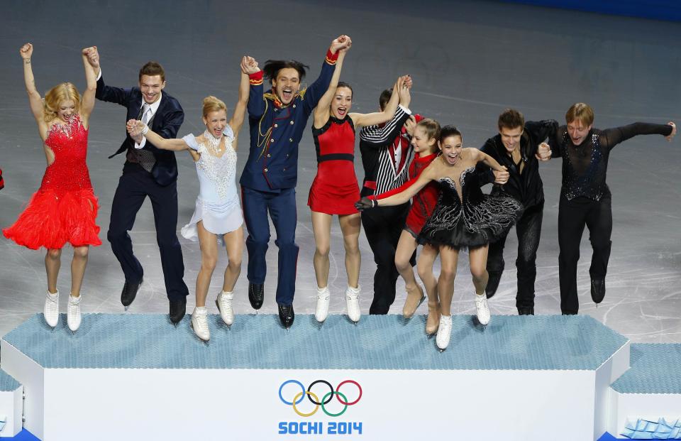 The Russian figure skating team steps onto the podium at the Sochi 2014 Winter Olympics, in this February 9, 2014 file photo. REUTERS/Brian Snyder/Files (RUSSIA - Tags: SPORT FIGURE SKATING OLYMPICS TPX IMAGES OF THE DAY)