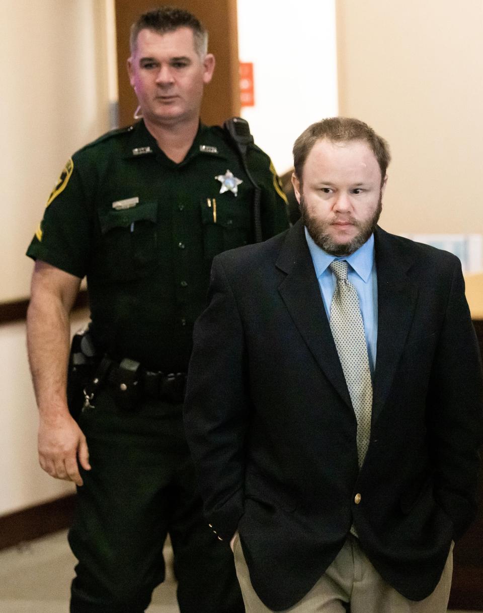 Michael Wayne Jones is escorted into the courtroom by a bailiff after a break on Friday.