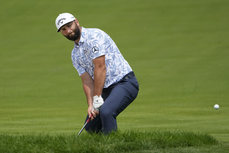 Jon Rahm watches his shot onto the 15th green sail sharply to his left off the green during the second round of the BMW Championship golf tournament, Friday, Aug. 18, 2023, in Olympia Fields, Ill. (AP Photo/Charles Rex Arbogast)