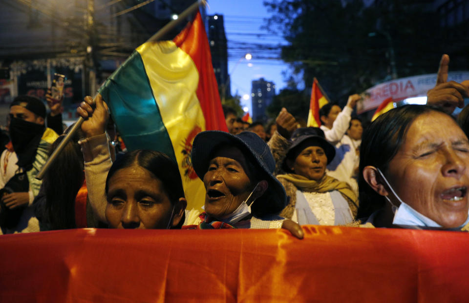 Protesters who are against the reelection of President Evo Morales gather outside the top electoral court to wait for the final results of last weekend's presidential election in La Paz, Bolivia, Wednesday, Oct. 23, 2019. Morales said Wednesday his opponents are trying to stage a coup against him as protests grow over a disputed election he claims he won outright, while a nearly finished vote count had him teetering on the threshold between getting the win or having to go to a runoff. (AP Photo/Juan Karita)