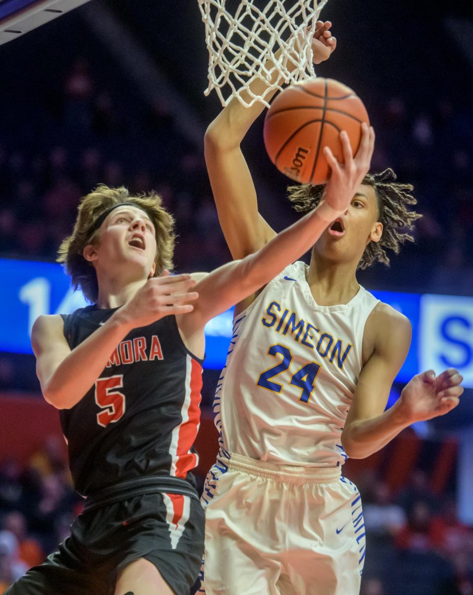 Metamora's Matthew Zobrist, left, moves to the basket against Chicago Simeon's Miles Rubin in the first half of their Class 3A state semifinal Friday, March 11, 2022 at the State Farm Center in Champaign. The Redbirds advanced to the state title game with a 50-47 win.