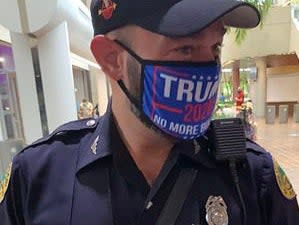 Miami Police officer Daniel Ubeda in a polling station in Miami ((Steve Simeonidis - Twitter))