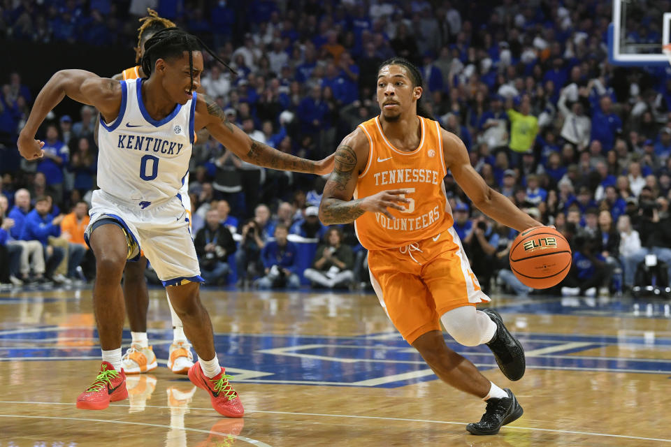 Tennessee guard Zakai Zeigler (5) drives past Kentucky guard Rob Dillingham (0) during the first half of an NCAA college basketball game in Lexington, Ky., Saturday, Feb. 3, 2024. (AP Photo/Timothy D. Easley)