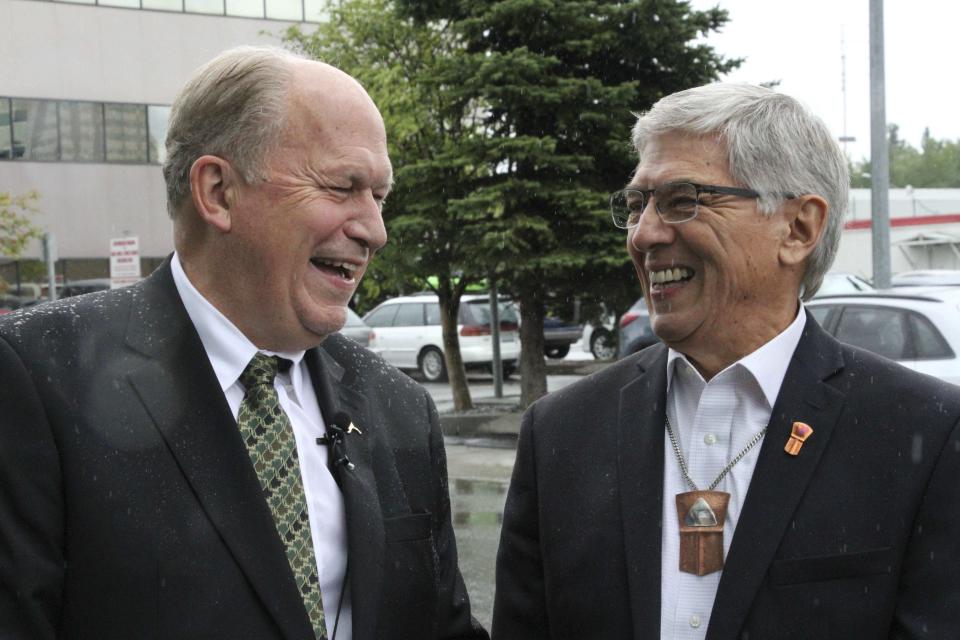 Alaska Gov. Bill Walker, left, and Lt. Gov. Byron Mallott laugh at an outdoors news conference in Anchorage, Alaska, on Monday, Aug. 20, 2018, after the two men submitted signatures to get their ticket on the November general election ballot. Walker is an independent and Mallott is a Democrat, and they decided to gather signatures to advance to the November election instead of taking part in the primary election on Aug. 21. (AP Photo/Mark Thiessen)