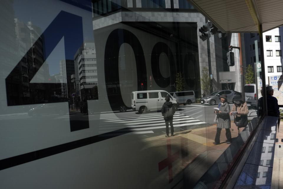 Japan's Nikkei 225 index is seen on an electronic stock board at a securities firm Friday, March 22, 2024, in Tokyo. Stocks were mostly lower Friday in Asia after Wall Street tapped fresh records, led by big gains in chipmakers. (AP Photo/Eugene Hoshiko)