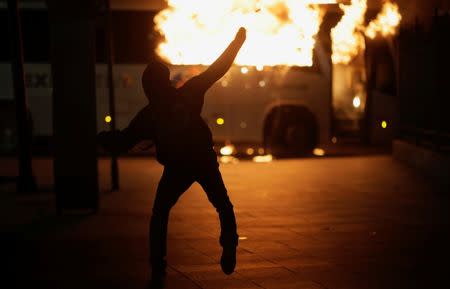 A demonstrator clashes with riot police during a protest against President Michel Temer's proposed reform of Brazil's social security system in Rio de Janeiro, Brazil, April 28, 2017. REUTERS/Ricardo Moraes