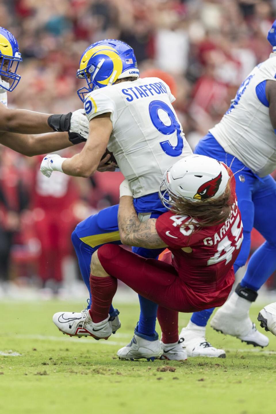 Rams quarterback Matthew Stafford (9) is sacked by Cardinals linebacker Dennis Gardeck (45).