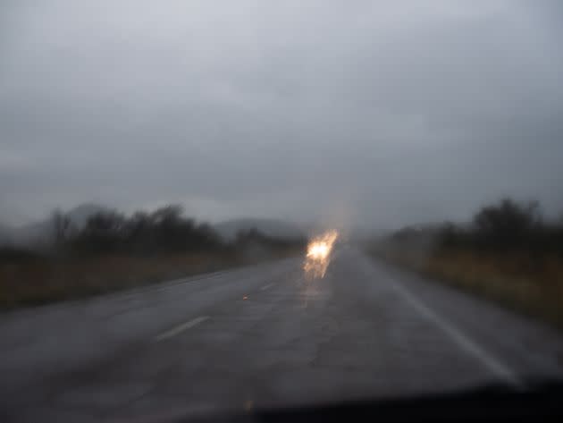 Approaching headlights blur in the rainfall between Bisbee and Tombstone. (Photo: Molly Peters for HuffPost)