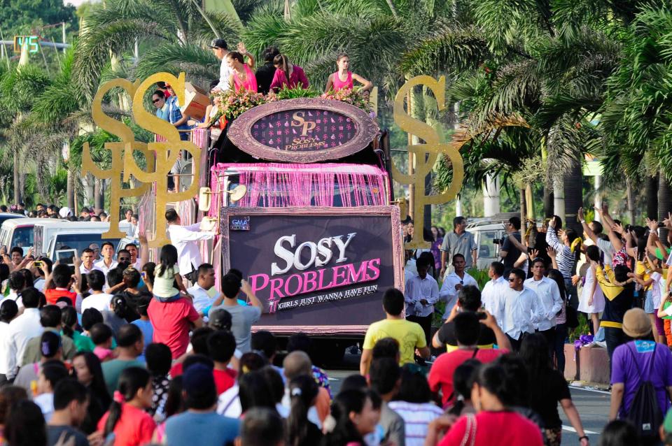 The casts of the MMFF 2012 entry "Sosy Problems" wave to the crowd as their float makes its way at the 2012 Metro Manila Film Festival Parade of Stars on 23 December 2012. (Angela Galia/NPPA Images)