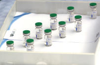 Vials of the Sputnik V vaccine placed on a table prior to the visit of Serbian President Aleksandar Vucic in Belgrade, Serbia, Thursday, April 15, 2021. Serbia has announced it will begin packing and later producing Russia's Sputnik V coronavirus vaccine, which would make it the first European state outside Russia and Belarus to begin manufacturing the jab. (AP Photo/Darko Vojinovic)