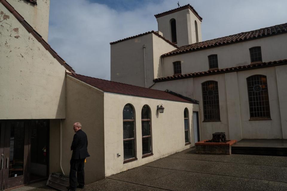 Pastor Todd Benson walks through a courtyard before joining congregants for lunch at Bethlehem Lutheran Church.