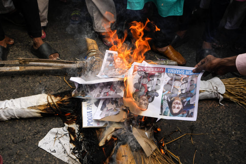 Indian Muslims burn an effigy with portraits of Nupur Sharma, the spokesperson of governing Hindu nationalist party and former lawmaker Naveen Jindal, as they react to the derogatory references to Islam and the Prophet Muhammad in Kolkata, India, Friday, June 10, 2022. Thousands of Muslims emerging from mosques after Friday prayers held street protests and hurled rocks at the police in some Indian towns and cities over remarks by two officials from India’s ruling party that were derogatory to the Prophet Muhammad. (AP Photo/Bikas Das)