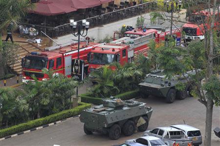 Fire engines and armoured military vehicles are pictured in front of Westgate shopping centre after explosions at the mall in Nairobi September 23, 2013. REUTERS/Noor Khamis