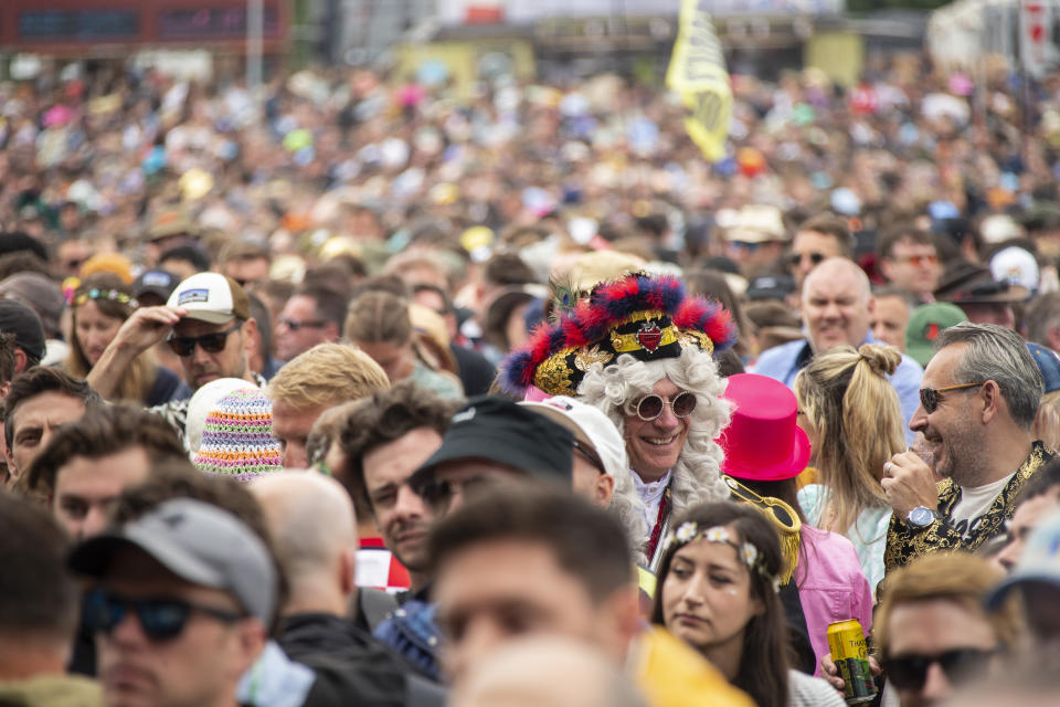 Festival goers make their way around the Glastonbury Festival in Worthy Farm, Somerset, England, Friday, June 24, 2022. (Photo by Joel C Ryan/Invision/AP)