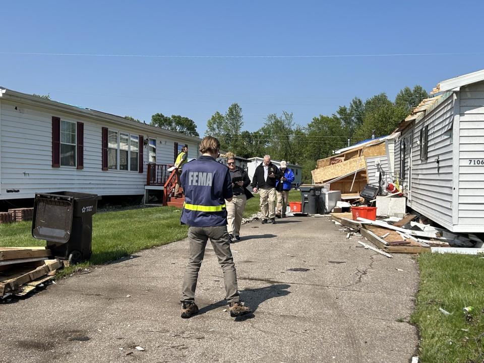 Federal, state, and local personnel survey storm damage at Oak Brook Estates mobile home park on Wednesday, May 15, 2024 in Portage.