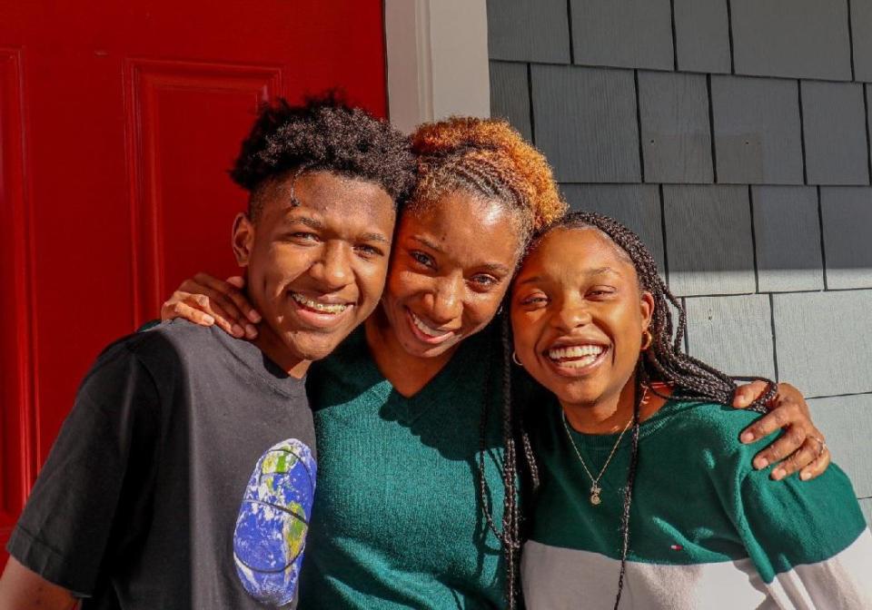 Robin Valentine, graduate of the Compass FSS program with Metro Housing Boston, with her children outside their newly purchased home.