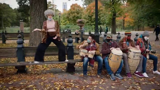 Kate McKinnon dressed as an old lady, dancing on a Central Park bench next to a group of musicians in "Saturday Night Live"