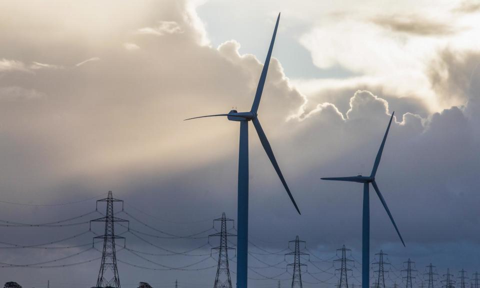 <span>Wind turbines and electricity pylons.</span><span>Photograph: Getty Images/Bloomberg Creative Photos</span>