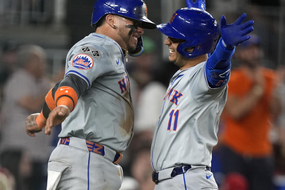 New York Mets' Francisco Alvarez, left, celebrates with teammate Jose Iglesias, right, after Iglesias hit a two-run home run during the 10th inning of a baseball game at Nationals Park, Monday, July 1, 2024, in Washington. (AP Photo/Mark Schiefelbein)