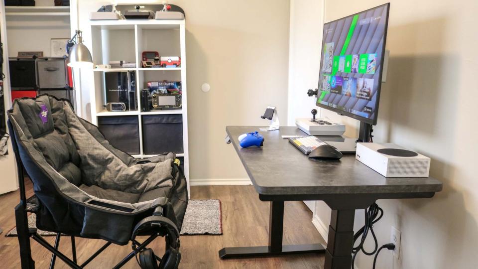 The Folding Gaming Chair next to a desk with an Xbox Series S