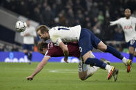 Tottenham's Harry Kane, top, duels for the ball with West Ham's Craig Dawson during the English League Cup quarterfinal soccer match between Tottenham Hotspur and West Ham United at the Tottenham Hotspur Stadium in London, Wednesday, Dec. 22, 2021. (AP Photo/Rui Vieira)