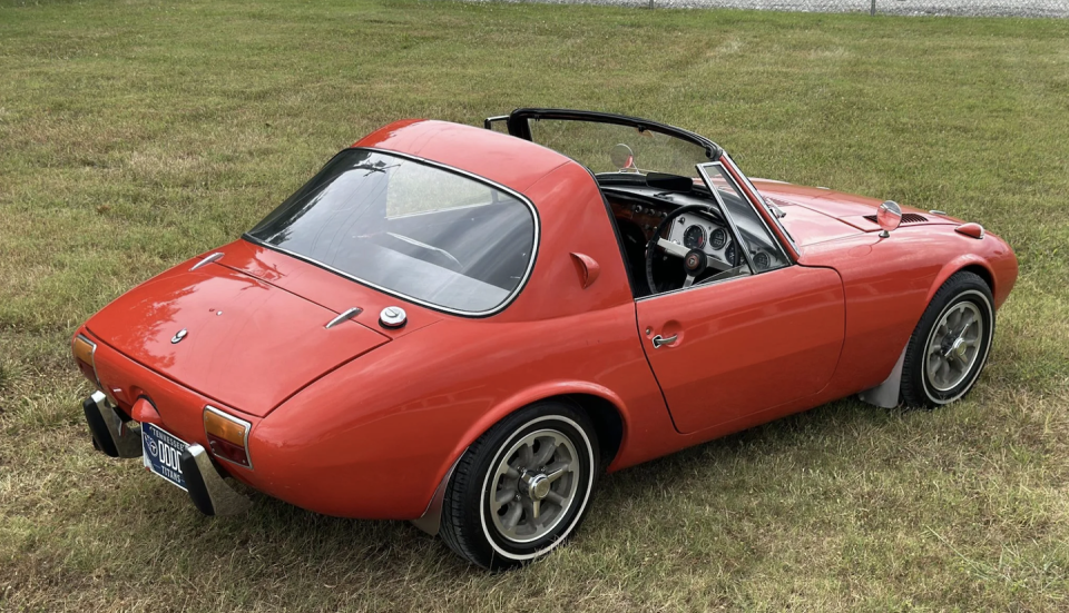 a red sports car parked on grass