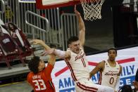 Illinois's Coleman Hawkins fouls Wisconsin's Micah Potter during the first half of an NCAA college basketball game Saturday, Feb. 27, 2021, in Madison, Wis. (AP Photo/Morry Gash)