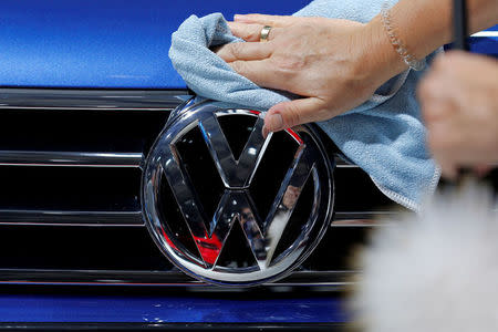 FILE PHOTO: A worker shines the grill of a Volkswagen car displayed on media day at the Paris auto show. September 30, 2016. REUTERS/Benoit Tessier/File Photo