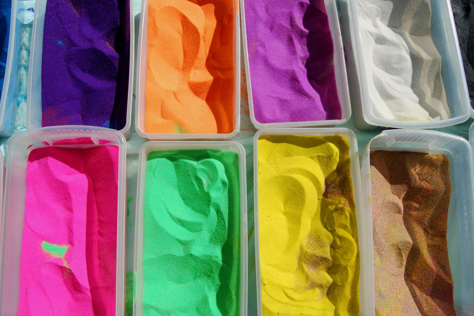 Close-up of colored sand and a Carnival Sand Art booth.