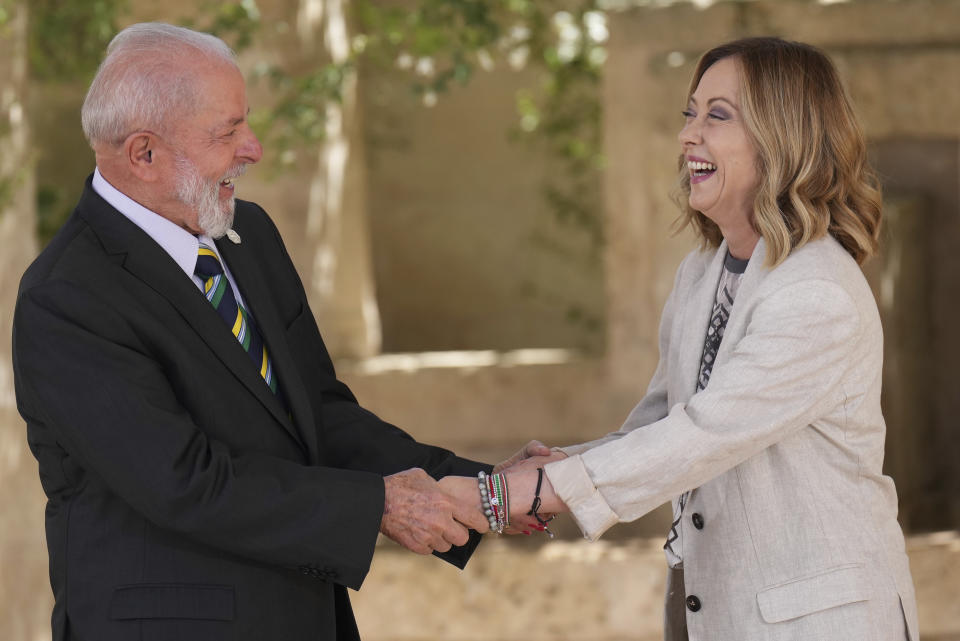 Luiz Inácio Lula da Silva, President of Brazil, left, shares a light moment with Italy's Prime Minister Giorgia Meloni as he is welcomed on day two of the 50th G7 summit at Borgo Egnazia, southern Italy, on Friday, June 14, 2024. (Christopher Furlong/Pool Photo via AP)