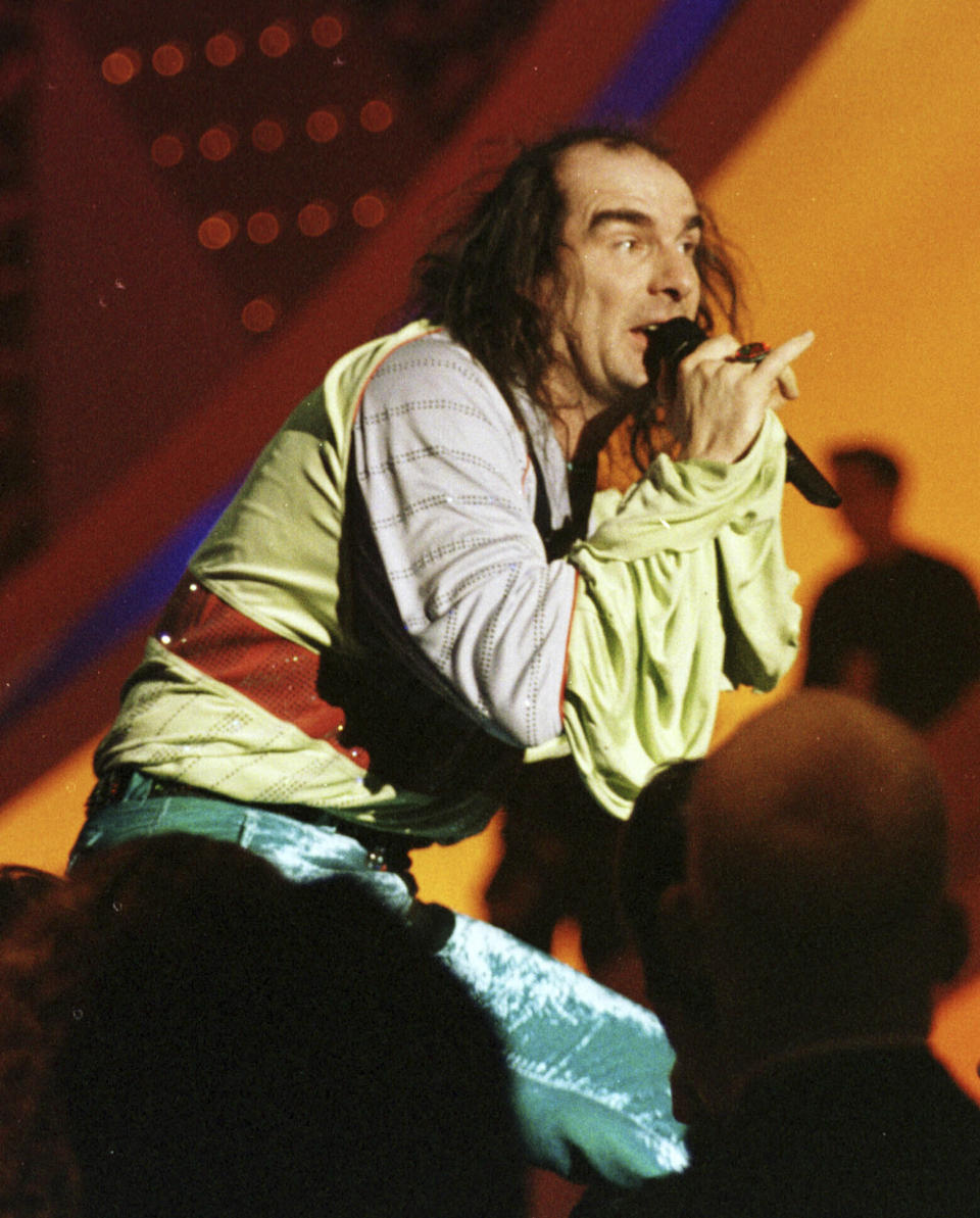FILE - Germany's Guildo Horn performs on stage in the final dress rehearsal in Birmingham, England, Saturday, May 9, 1998, ahead of the final. The 68th Eurovision Song Contest is taking place in May in Malmö, Sweden. It will see acts from 37 countries vie for the continent’s pop crown. Founded in 1956, Eurovision is a feelgood extravaganza that strives to banish international strife and division. It’s known for songs that range from anthemic to extremely silly, often with elaborate costumes and spectacular staging. (AP Photo/Louisa Buller, File)