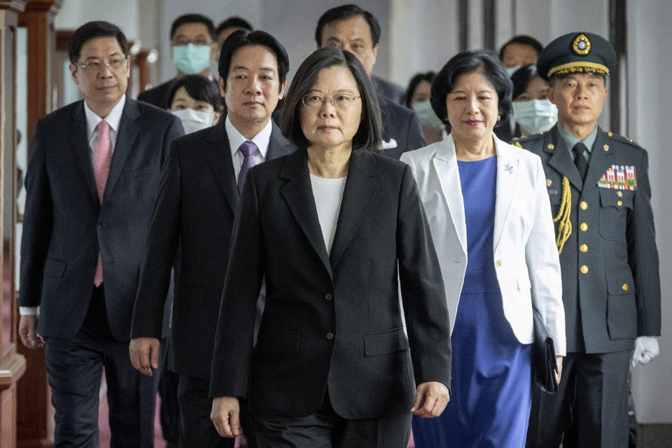 In this photo released by the Taiwan Presidential Office, Taiwanese President Tsai Ing-wen, center, walks ahead of Vice-President Lai Ching-te, left of her, as they attend an inauguration ceremony in Taipei, Taiwan, Wednesday, May 20, 2020. Tsai was inaugurated for a second term amid increasing pressure from China on the self-governing island democracy it claims as its own territory. (Taiwan Presidential Office via AP)