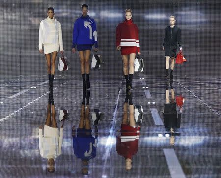 Models present creations from the Anya Hindmarch Autumn/Winter 2015 collection during London Fashion Week February 24, 2015. REUTERS/Suzanne Plunkett