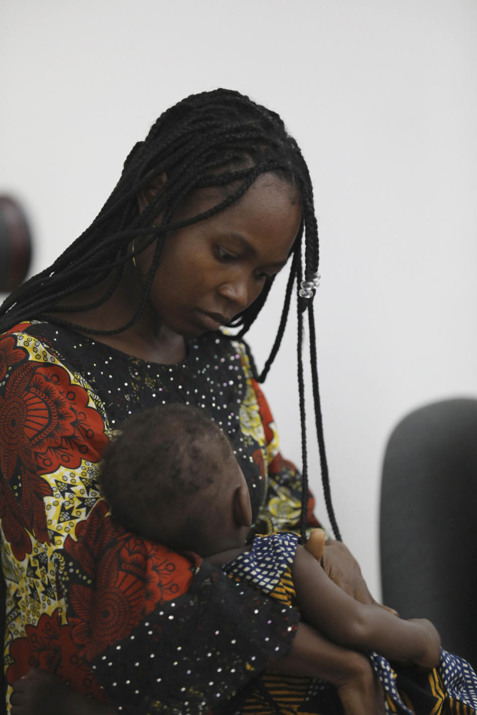 Jummai Mutah, one of the Chibok schoolgirls who was kidnapped in 2014 by Islamic extremists and later released, plays with her baby as she attends a 10th anniversary event of the abduction in Lagos, Nigeria, Thursday, April 4, 2024. A new film in Nigeria is being screened to remember the nearly 100 schoolgirls who are still in captivity 10 years after they were seized from their school in the country’s northeast. At least 276 girls were kidnapped during the April 2014 attack, but most have since regained their freedom. (AP Photo/Mansur Ibrahim )