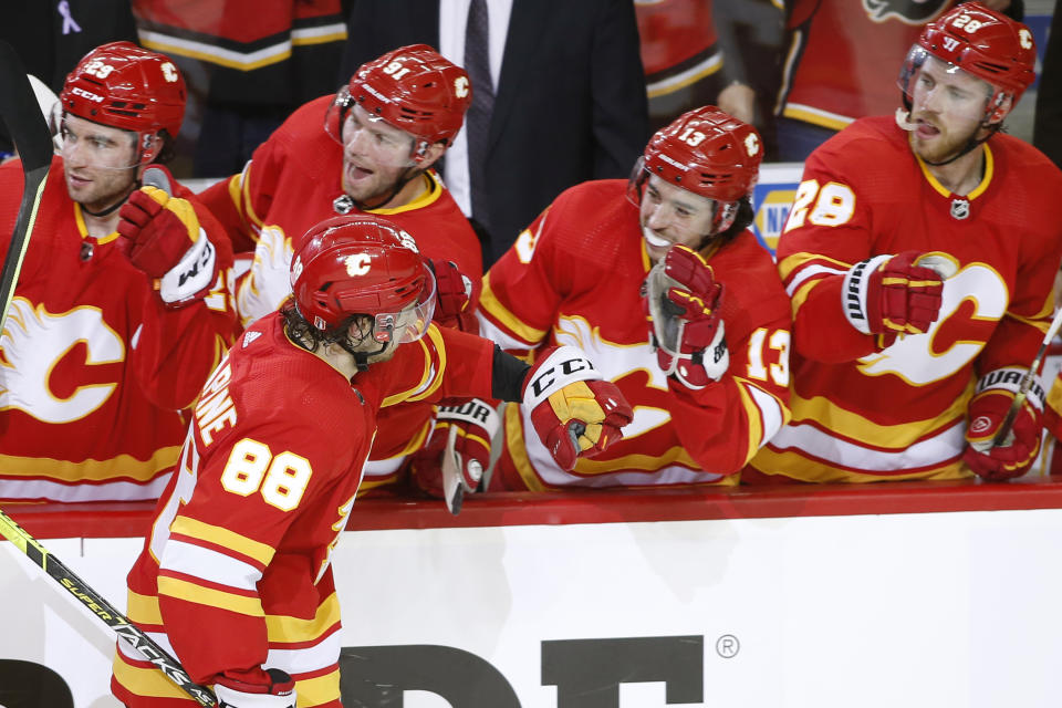 Calgary Flames left wing Andrew Mangiapane (88) celebrates his game winning goal against the Dallas Stars with teammates during the third period in Game 5 of an NHL hockey Stanley Cup first-round playoff series, Wednesday, May 11, 2022 in Calgary, Alberta. (Larry MacDougal/The Canadian Press via AP)