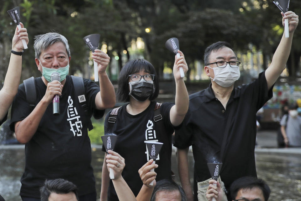 FILE - In this June 4, 2020, file photo, from left, pro-democracy activists Lee Cheuk-yan, Chow Hang Tung, and Cheung Man-kwong attend a gathering to mourn for those killed in the 1989 Tiananmen crackdown at Victoria Park, in Hong Kong. Hong Kong tycoon and prominent pro-democracy activist Jimmy Lai and two others were convicted Thursday, Dec. 9, for their roles in last year's banned Tiananmen candlelight vigil, amid a crackdown on dissent in the city and Beijing's tightening political control. (AP Photo/Kin Cheung, File)