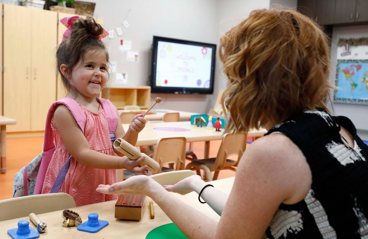 Lincoln Hughes playes with teacher Alysia Brooks during the Open House evening at the new Early Childhood center in Republic on August 15, 2023.