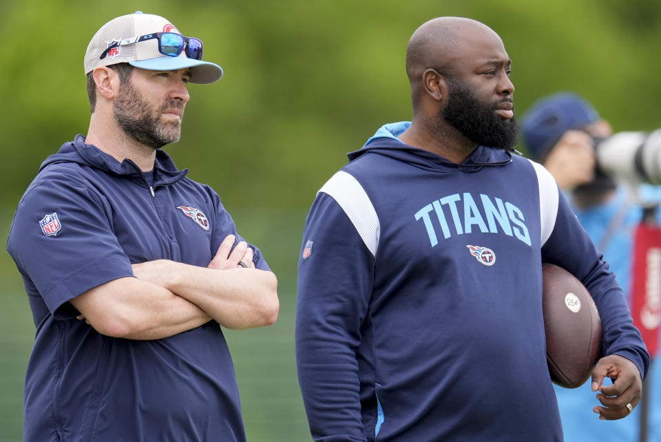 Tennessee Titans head coach Brian Callahan, left, and general manager Ran Carthon watch players warmup during an NFL rookie minicamp football practice Friday, May 10, 2024, in Nashville, Tenn. (AP Photo/George Walker IV)