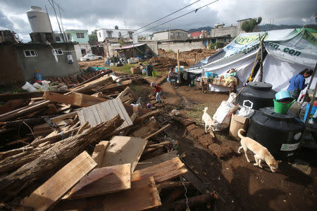 A child plays near a makeshift tent after his family's home was damaged in an earthquake, in San Simon el Alto, Mexico September 23, 2017. REUTERS/Edgard Garrido