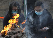 <p>Relatives burn paper money as they pay last tributes to bus crash victims in Hong Kong, Feb. 11, 2018. (Photo: Vincent Yu/AP) </p>